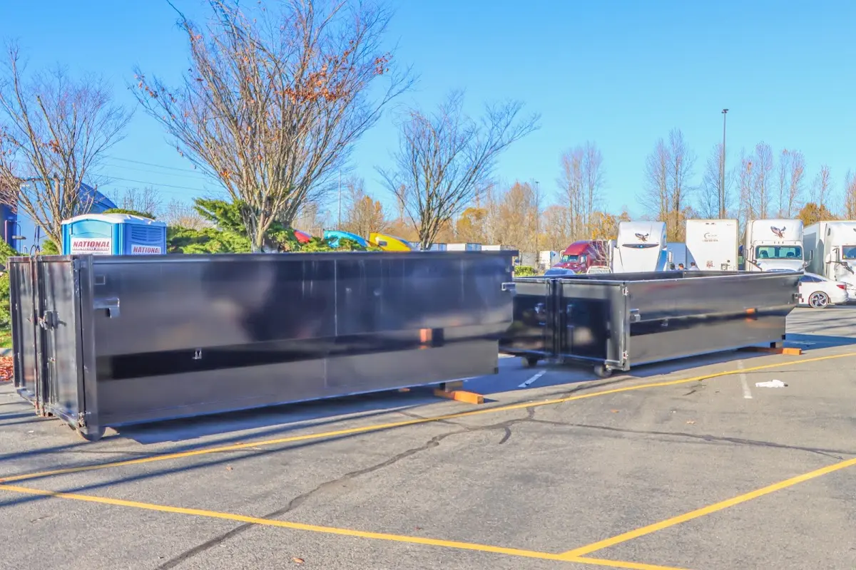 Professional dumpster rental service with roll-off container on residential driveway in Cherry Hill